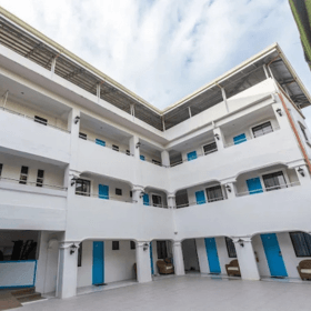 Boracay budget hotel courtyard with modern white building and rooms affordable accommodation in Boracay Philippines