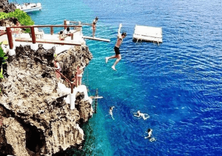 Boracay cliff diving activity with tourists jumping into clear blue water adventure in Boracay Philippines