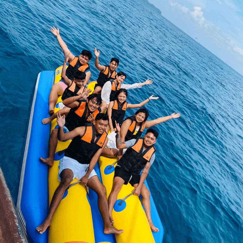Boracay banana boat ride with group of tourists enjoying water activities in Boracay Philippines