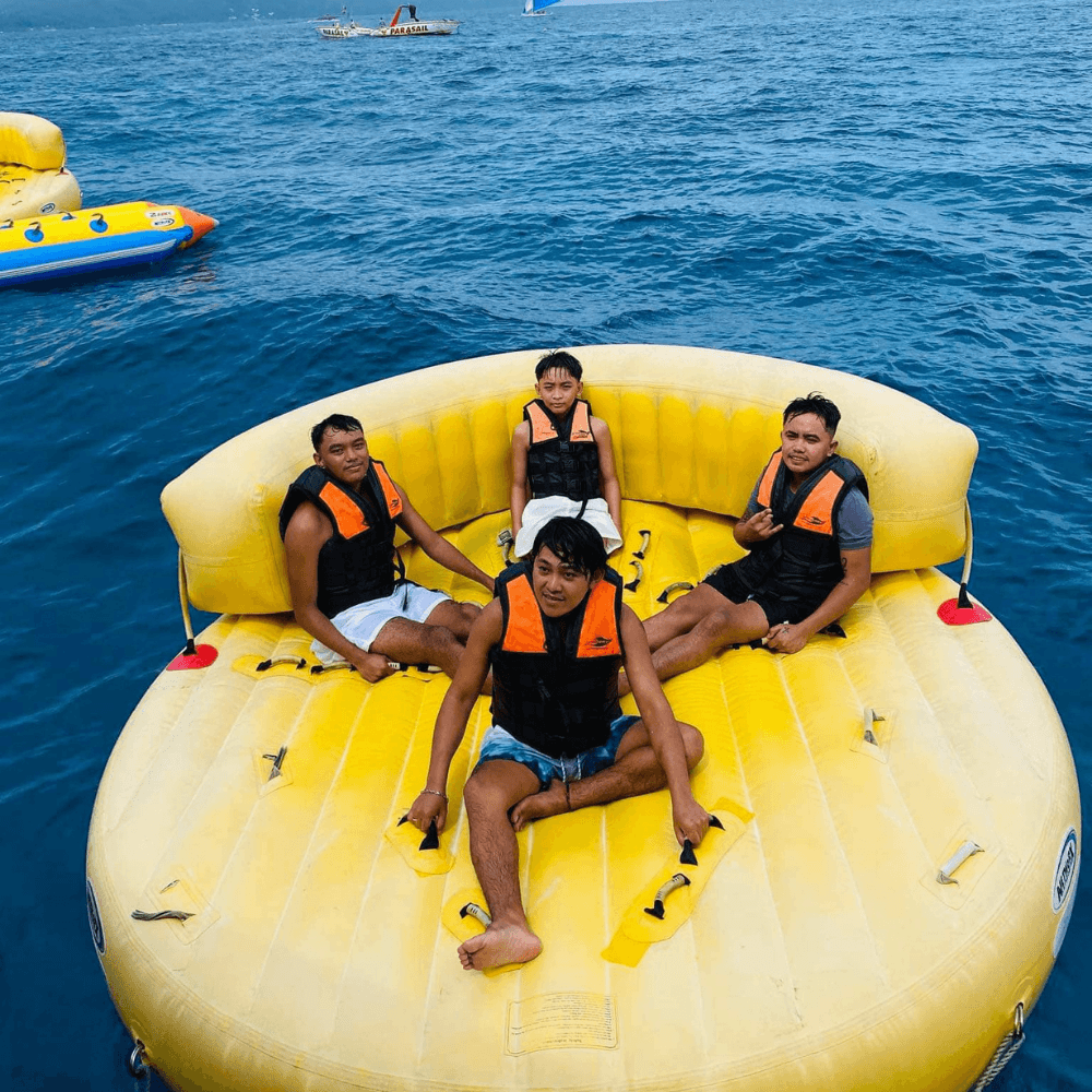 Boracay banana boat ride with tourists enjoying water activities in Boracay Philippines