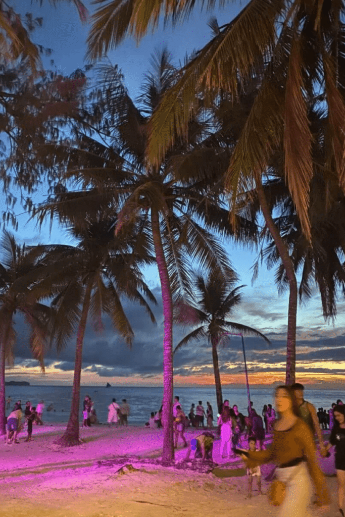 Boracay beach with palm trees and sunset nightlife.