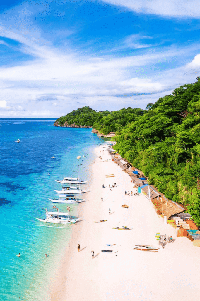 Boracay white sand beach with turquoise waters and tropical coastline.