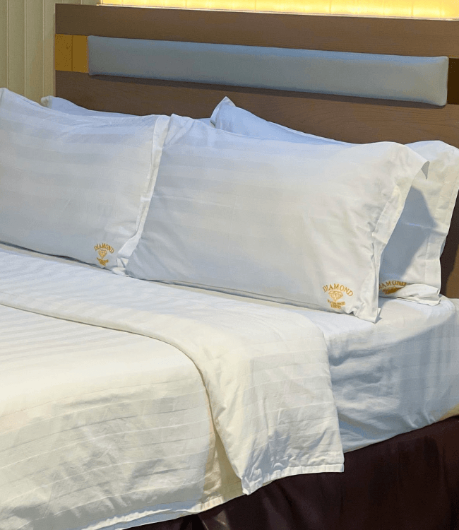 Diamond Water Edge Resort Boracay bed with clean luxury linens.