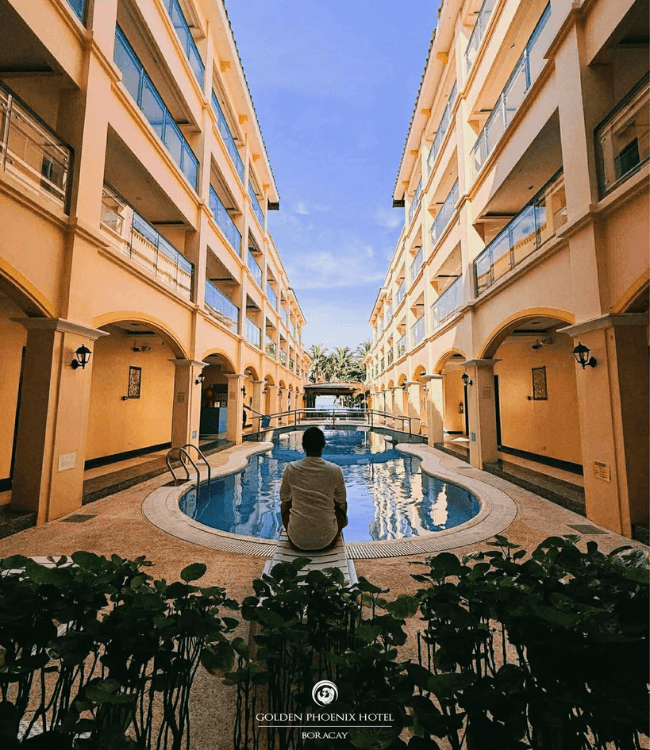 Golden Phoenix Hotel Boracay pool area with resort buildings.