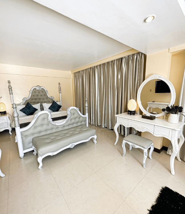 Golden Phoenix Boracay suite with elegant bedroom and vanity area.