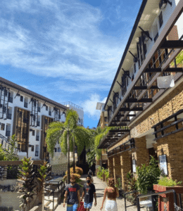 Boracay resort walkway with modern buildings and tropical plants.